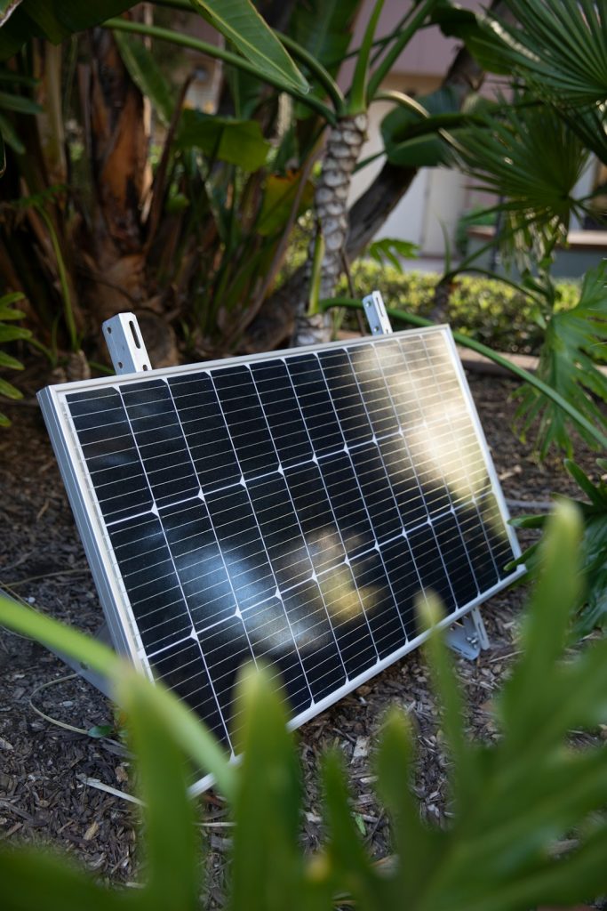 a-solar-panel-laying-on-the-ground-in-a-garden-jlb7b-fkkfi